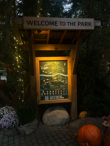 Hinweisschild "Willkommen im Park" mit Lageplan und Kürbissen im Vordergrund.